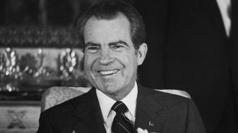 American President Richard Nixon smiling at the White House