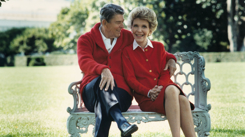 President Ronald Reagan and First Lady Nancy Reagan share a moment on a bench in the sun