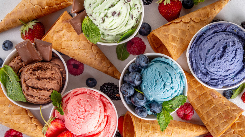 Scoops of various ice cream flavors, with cones