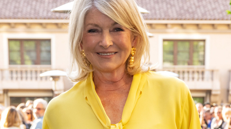 Martha Stewart smiles in a yellow top at an event