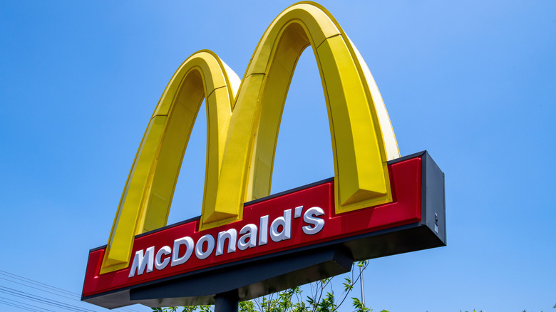 Close up of a stand-alone McDonald's sign with the golden arches against a blue sky