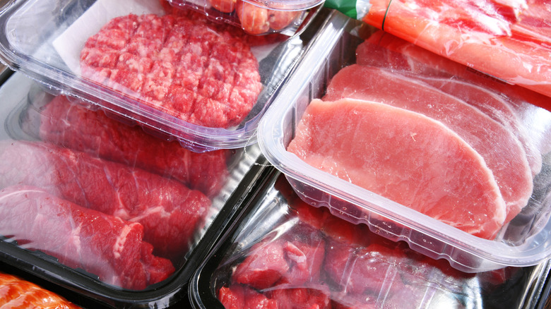 Composition with packages of assorted meat products.