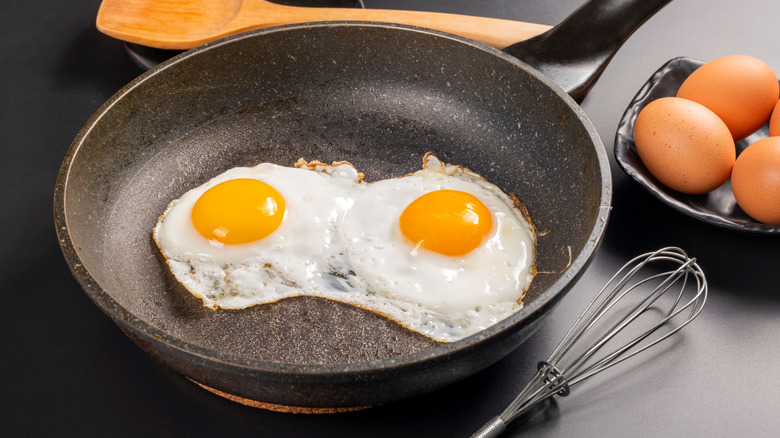 fried eggs in a black cast iron pan