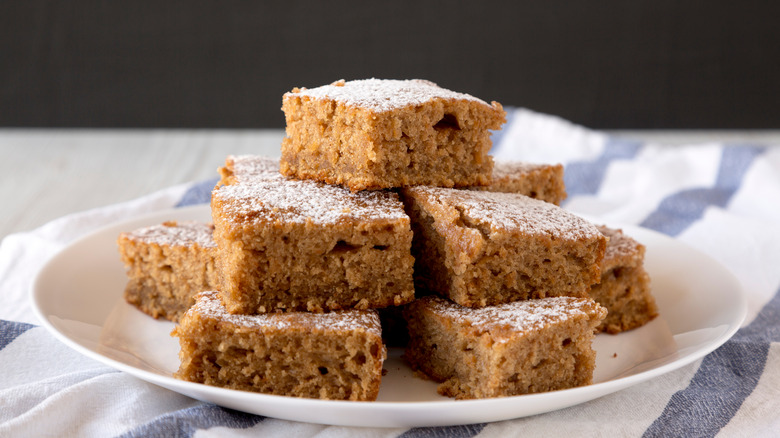 Squares of homemade applesauce cake on a white plate