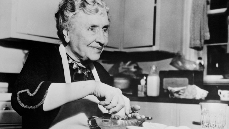 Older Helen Keller at home in her kitchen