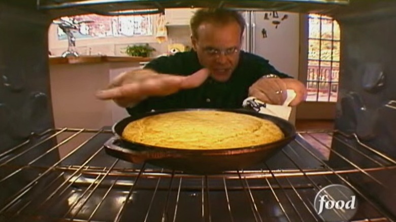 Alton Brown standing before an oven in an early episode of "Good Eats."