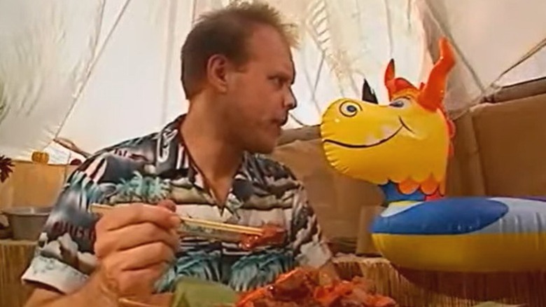 Alton Brown conversing with a pool toy on an episode of "Good Eats."