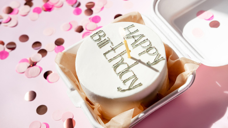 A mini cake decorated with the words "happy birthday"