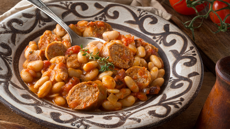 French cassoulet dish on a plate with rustic plating.