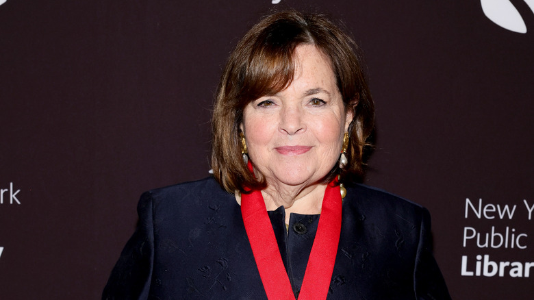 Ina Garten in a dressy black jacket against a dark background