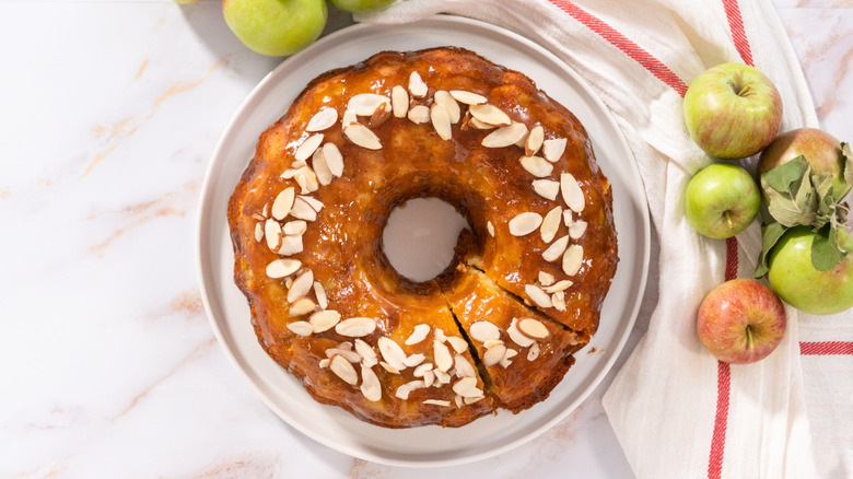 Top view of glazed apple cider Bundt cake with almonds
