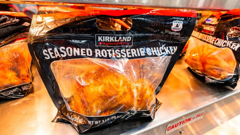 Costco rotisserie chicken in bag under heat lamp