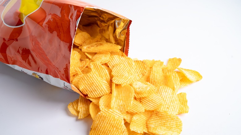 potato chip bag spilled over with chips falling out