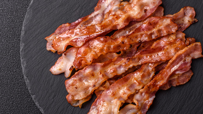 Cooked strips of bacon on a plate