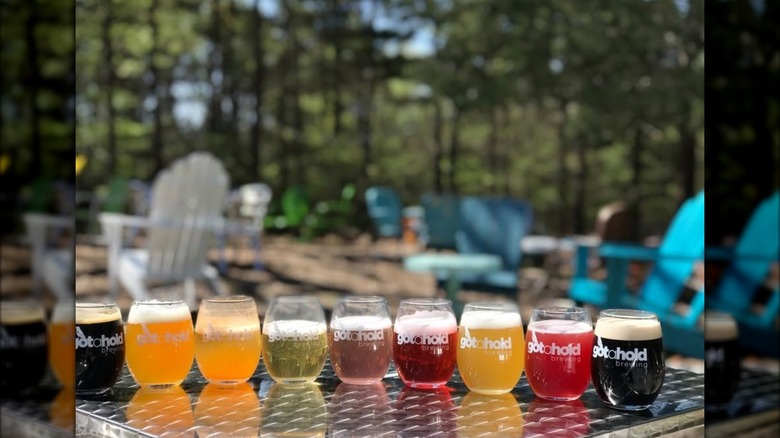 A row of Gotahold beers on a tabletop, exterior