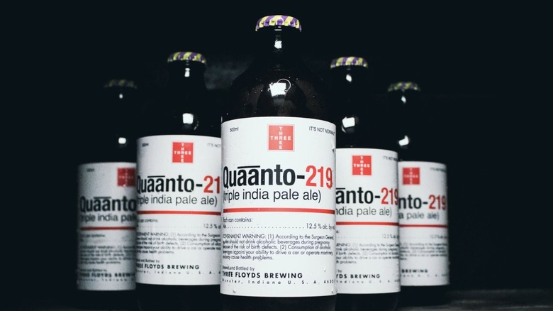 A triangular lineup of triple IPA bottles from 3 Floyds