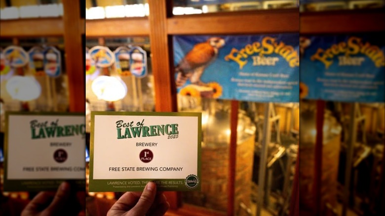 A "best of" postcard held in front of Free State Beer taps