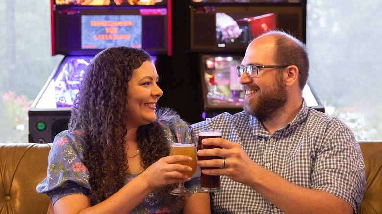 Two customers toasting in Jailbreak brewery with two pints of beer