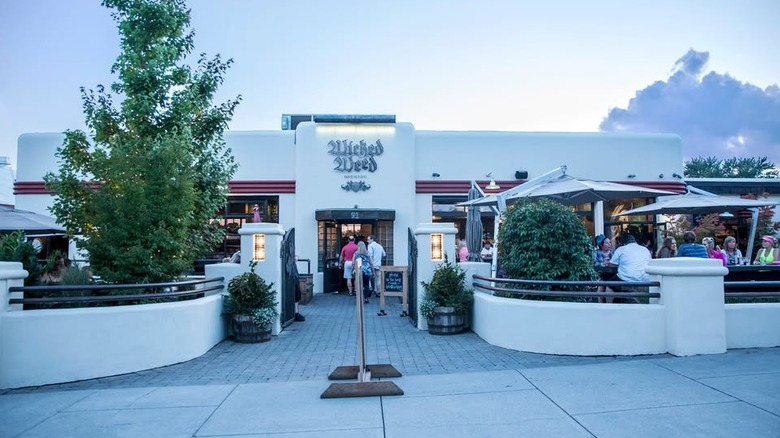 Exterior of Wicked Weed Brewpub with outdoor patio and trees