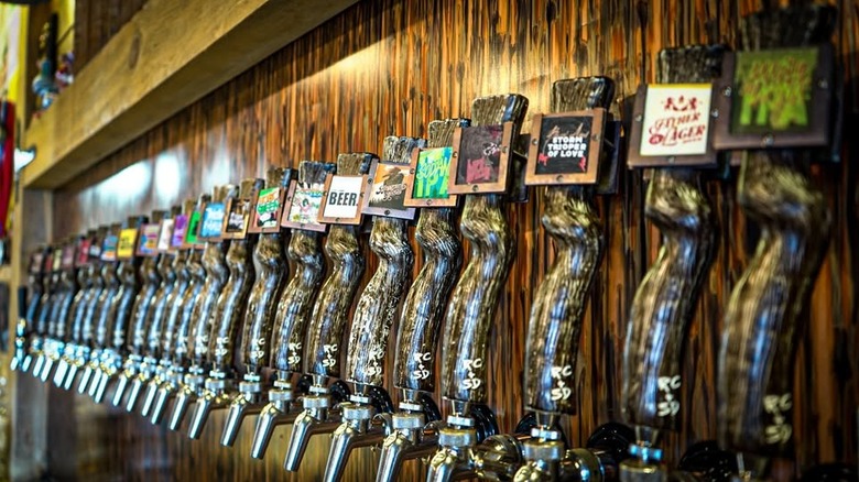 A row of beer taps on wooden wall at Lost Cabin Brewing