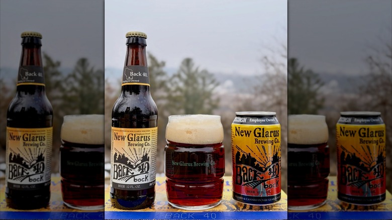 A bottled, a poured beer, and a can of New Glarus Brewing, outside