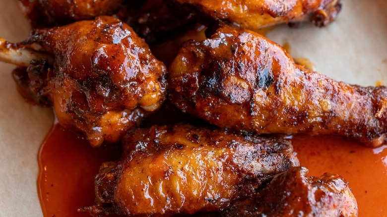 Saucy chicken wings on a white plate