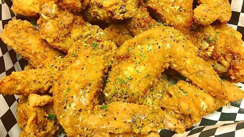 Lightly fried lemon pepper chicken wings on a checkered piece of paper