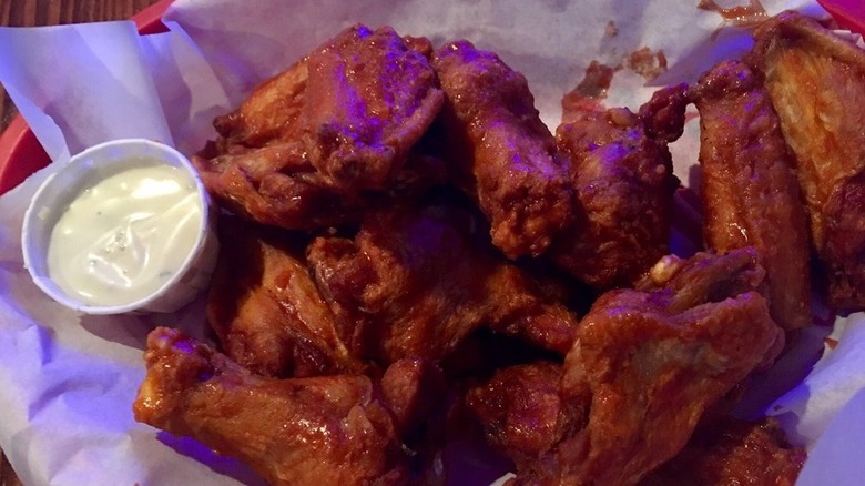 Basket of saucy wings with blue cheese