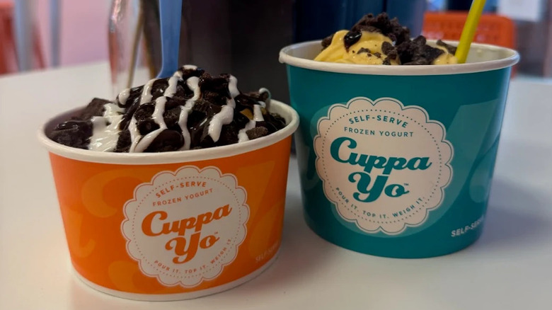 two cups of cuppa yo froyo with cookie crumbles on top