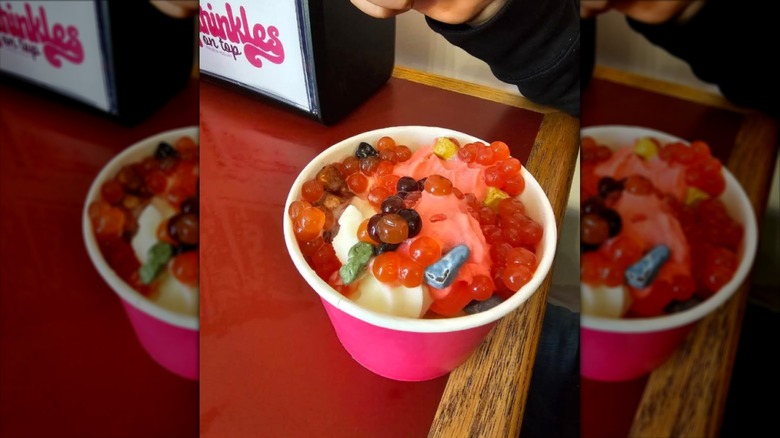 cup of froyo topped with candy and jellies
