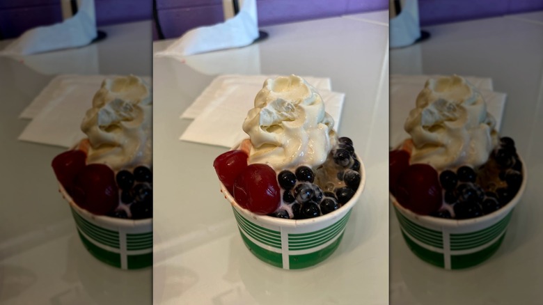 cup of creamy froyo with boba and cherries