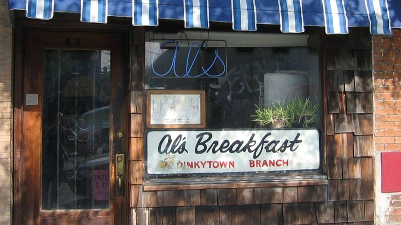 Exterior of Al's Breakfast with blue and white striped awning