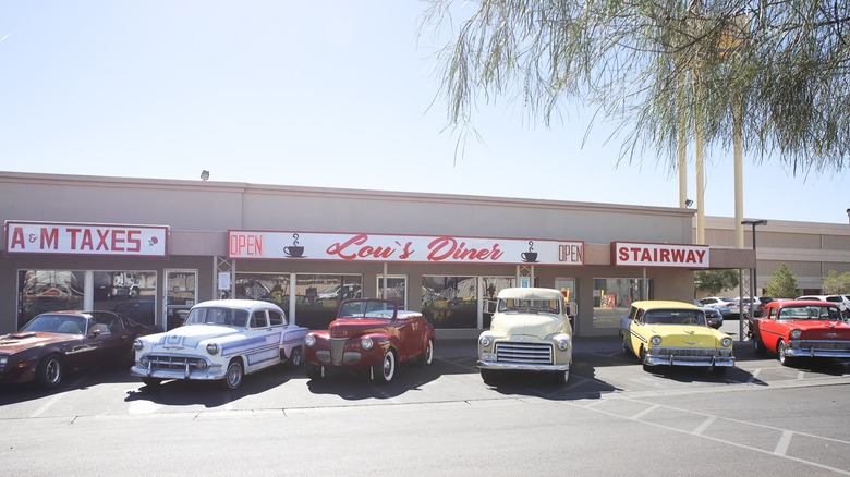 Exterior of Lou's Diner with old fashioned cars parked in lot