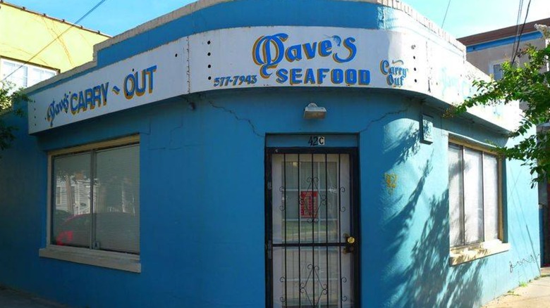 Blue exterior of Dave's Carry Out on streetfront