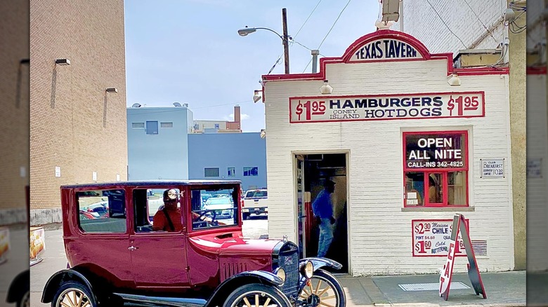 Exterior of Texas Tavern with vintage red car parked in front