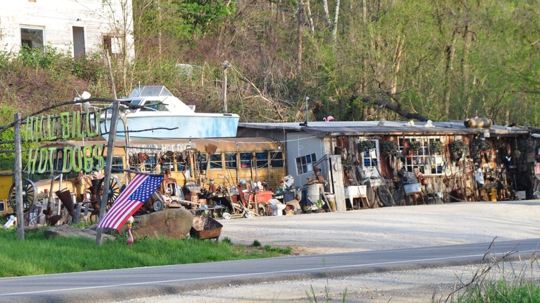 Exterior of Hillbilly Hot Dogs with a lot of scattered memorabilia and kitsche