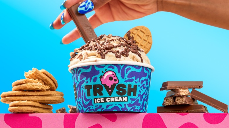 Trash Ice Cream cup with nutter butter cookies and kit kats alongside it