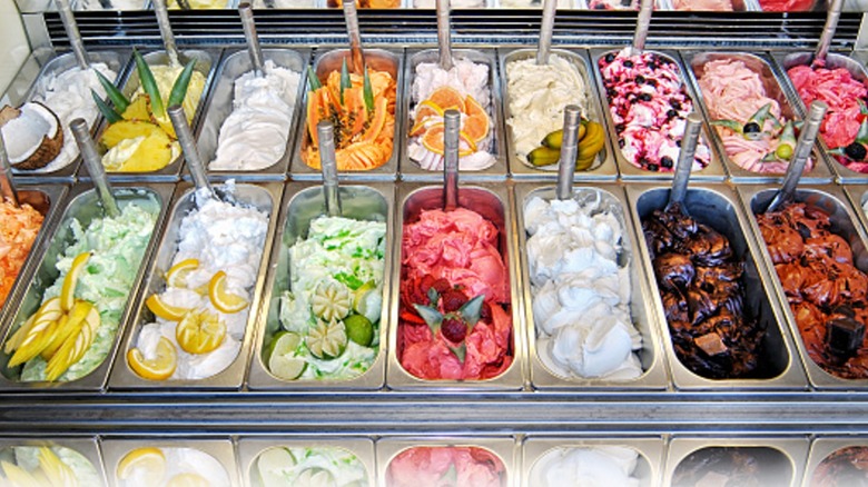 Display of assorted ice creams in metal tubs in a shop or ice cream parlour