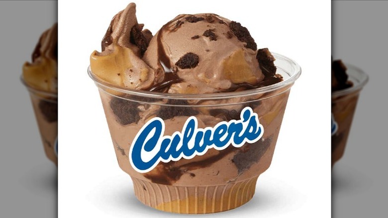 Culver's Peanut Butter Fudge Brownie frozen custard in a clear plastic cup with a Culver's logo on a white background.