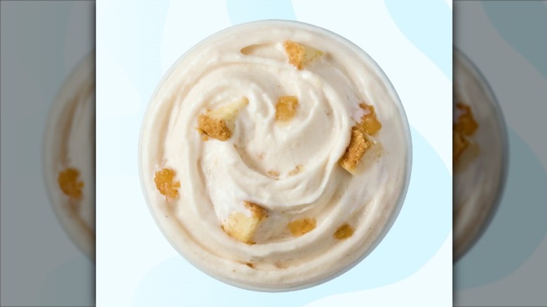 A top view of Caramel Apple Cheesecake Blizzard from Dairy Queen on a pale blue background.