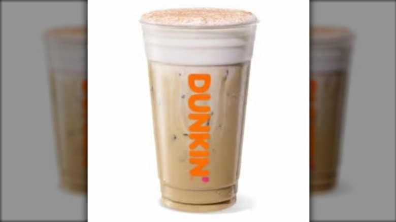 Tiramisu Cloud Latte in a large plastic cup bearing a Dunkin' logo on a white background.