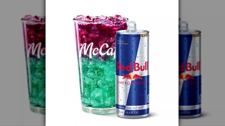 McDonald's Red Bull Dragonberry Energizer in a pint glass bearing a McCafe logo shown with a can of Red Bull on a white background.
