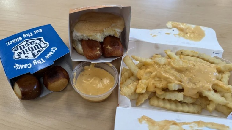 The new Garage Beer Cheese from White Castle alongside pretzel bites, a sandwich, and french fries
