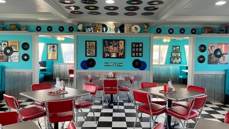 Interior of Dairy Dip Diner with retro vinyl records on wall and black and white checkered flooring