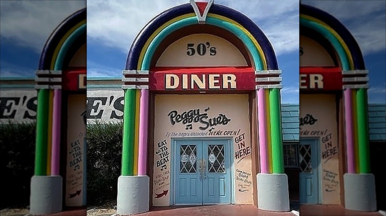 Exterior front entrance of Peggy Sue's 50's Diner appears similar to a front of a jukebox