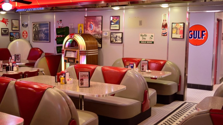 Interior dining area with red and white vinyl booths and jukebox at Dixie's Diner