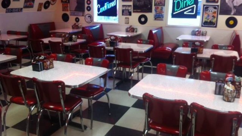 Interior dining area with bright red retro seats and vinyl records on the wall at Charlie Parker's Diner