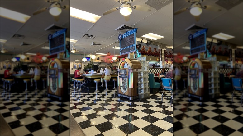 Interior dining area with jukebox and black and white checkered flooring at Hub City Diner