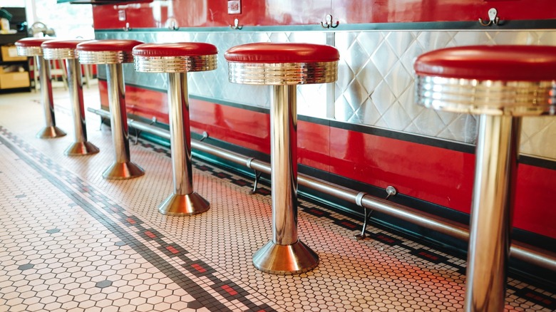 close up of old school diner counter seating with bar stools