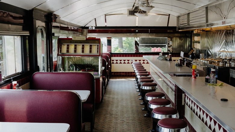 Interior dining area with vinyl booths and counter seating at The Roadside Diner